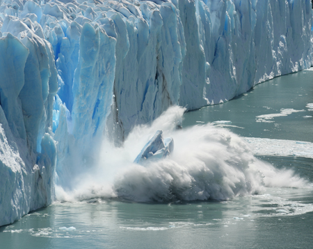 A glacier crashes into the sea.